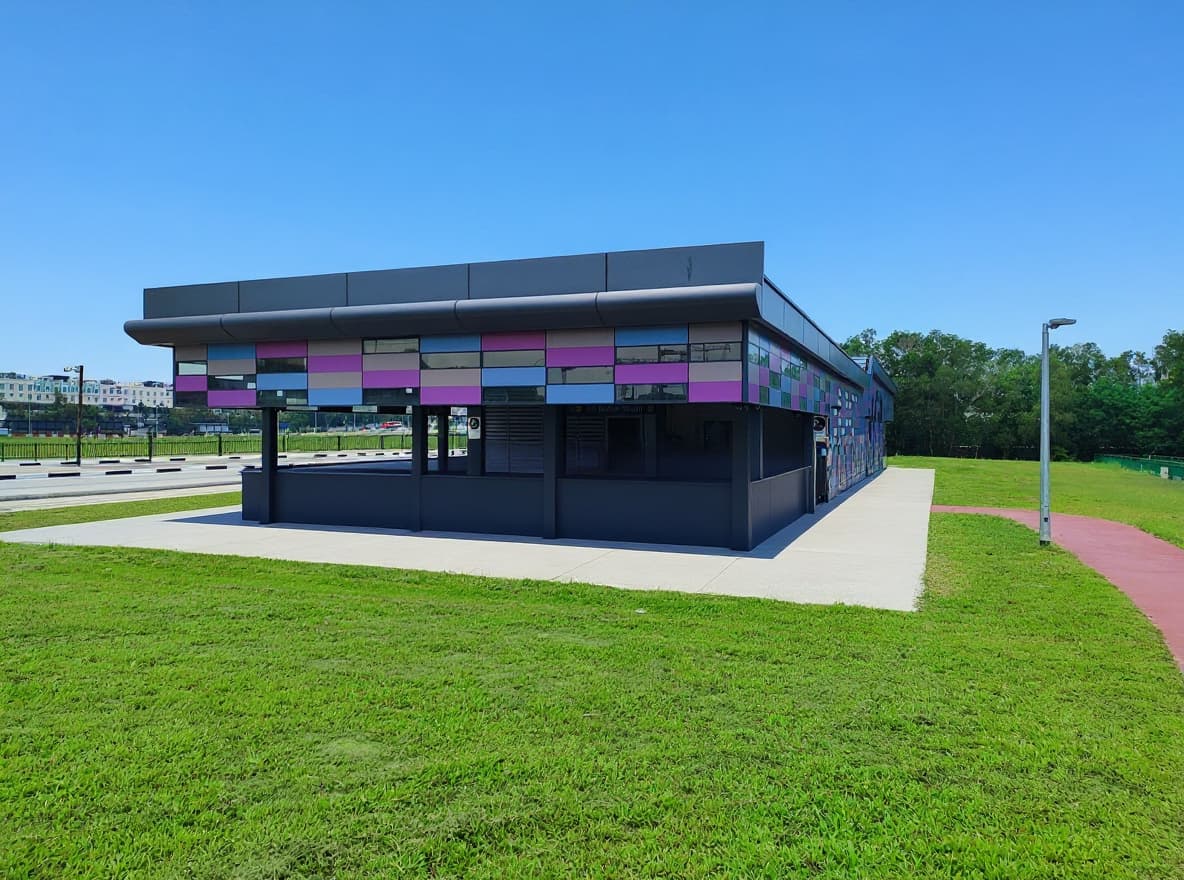 Street-level exit of Bedok South MRT station on the Thomson-East Coast Line, with its multicoloured cladding